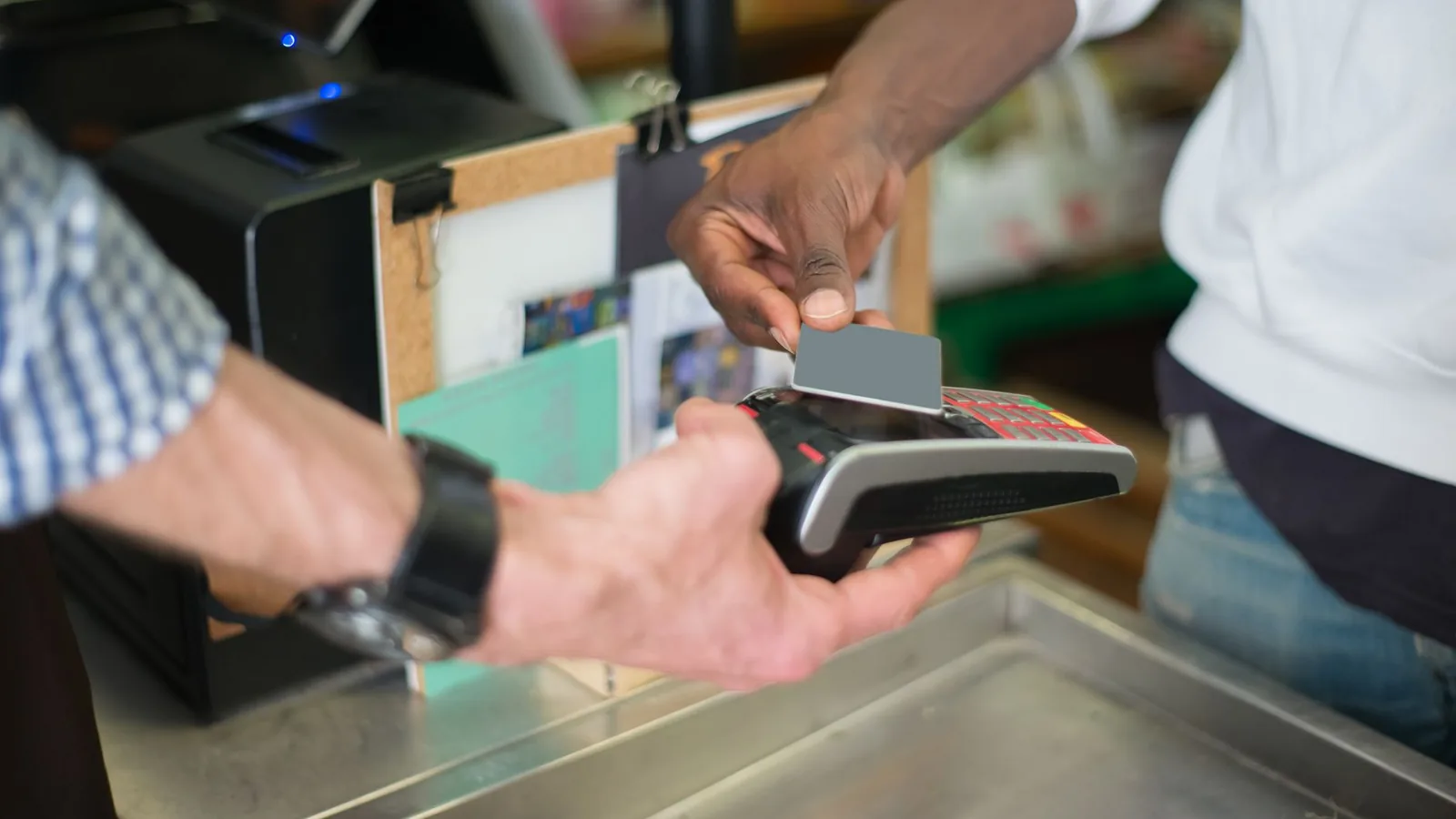 A contactless payment being made using a card reader at a retail store checkout counter.